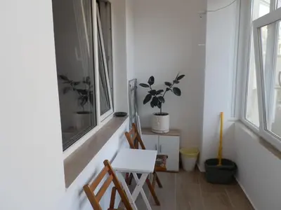 a room with two chairs and a table and two windows at Silver House in Varna City