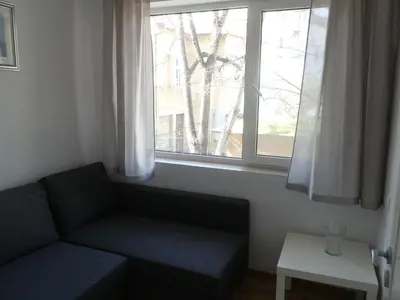a living room with a couch and a window at Silver House in Varna City
