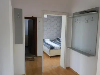a bedroom with a mirror and a bed in a room at Silver House in Varna City