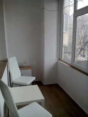 two chairs and a table in a room with a window at Silver House in Varna City