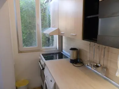 a small kitchen with a counter top and a window at Silver House in Varna City