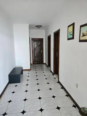 a hallway with a black and white tiled floor at Lazur SeaView Apartment in Pomorie