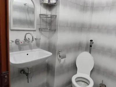 a bathroom with a toilet and a sink at Стаи за гости Петрови in Primorsko
