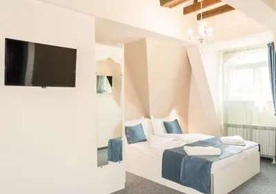 a bedroom with a bed and a flat screen tv at Family Hotel Belle Epoque Beach in Varna City