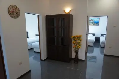 a hallway with a door and a vase of flowers at SeaSide Guest Rooms in Burgas City
