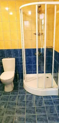 a bathroom with a toilet and a glass shower at Kaya Apartments in Sunny Beach