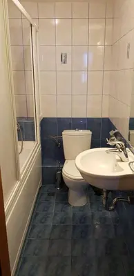 a bathroom with a toilet and a sink at Kaya Apartments in Sunny Beach