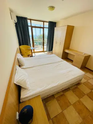 a bedroom with two beds and a window at Kaya Apartments in Sunny Beach
