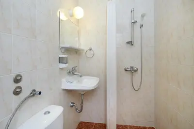 a bathroom with a shower and a sink and a toilet at Hotel Yantra in Sunny Beach