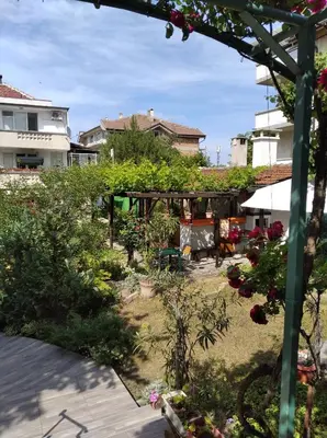 a garden with flowers and plants on a patio at Guesthouse Kolevi in Lozenets