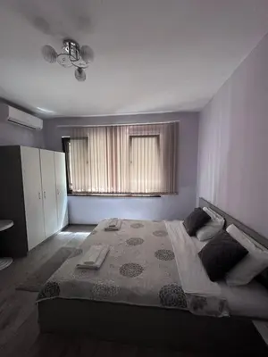 a bedroom with a large bed and a window at Saraya in Varna City