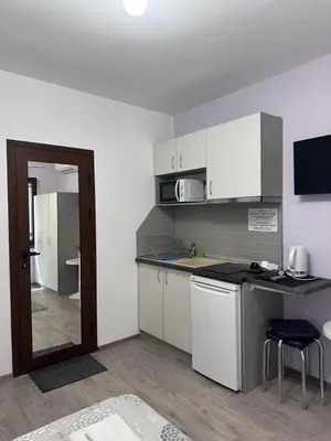 a kitchen with white cabinets and a counter top at Saraya in Varna City