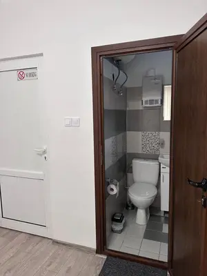 a small bathroom with a toilet and a shower at Saraya in Varna City