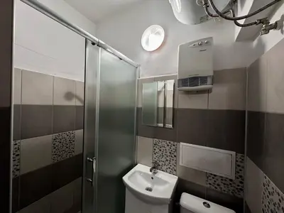 a bathroom with a toilet and a sink and a shower at Saraya in Varna City