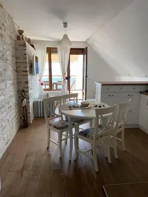 a kitchen with a table and chairs in a room at Apartment Nadejda in Pomorie