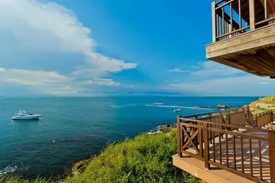 a view of the ocean from a balcony of a house at Sozopolis Holiday Village in Sozopol