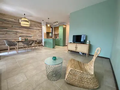 a living room with a couch and a table at Sozopolis Holiday Village in Sozopol