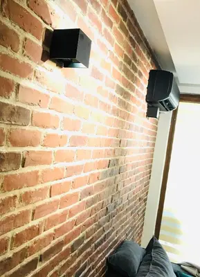 a brick wall with a tv on a brick wall at Bright, Comfortable and Cozy Apartment in Burgas City