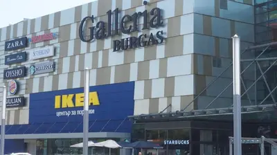 a building with a sign on the side of it at Bright, Comfortable and Cozy Apartment in Burgas City