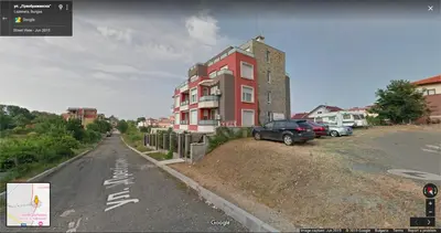 a red building on the side of a road at Charming Beach Holiday Apartment in Lozenets
