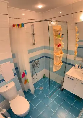 a bathroom with a shower and a toilet and a sink at Charming Beach Holiday Apartment in Lozenets