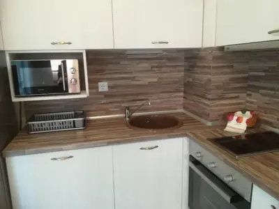 a kitchen with a sink and a microwave at Apartment Batoevi Sozopol in Sozopol