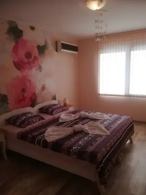 a bedroom with a bed with pillows on it at Apartment Batoevi Sozopol in Sozopol