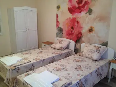 a bedroom with two beds and a painting on the wall at Apartment Batoevi Sozopol in Sozopol