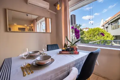 a table with a blue table cloth and a window at City Center apartament “MARTA” in Varna City