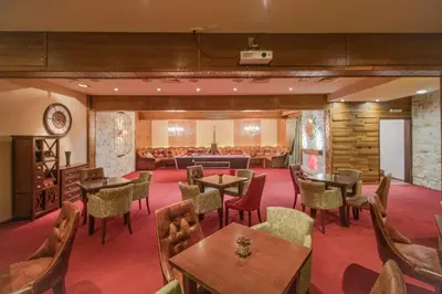 a restaurant with tables and chairs and a waiting room at Eco Complex Sherba in Debelets