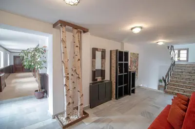 a living room with a staircase and a living room with a couch at Eco Complex Sherba in Debelets