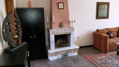a living room with a fireplace and a couch at Style Apartment in Pomorie