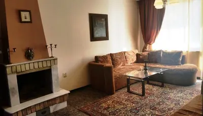a living room with a couch and a fireplace at Style Apartment in Pomorie