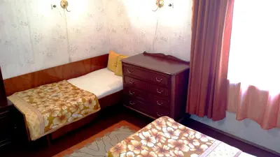 a small bedroom with a bed and a dresser at Style Apartment in Pomorie