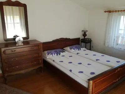 a bedroom with a bed and a dresser and a mirror at Apartment Marchela in Nesebar