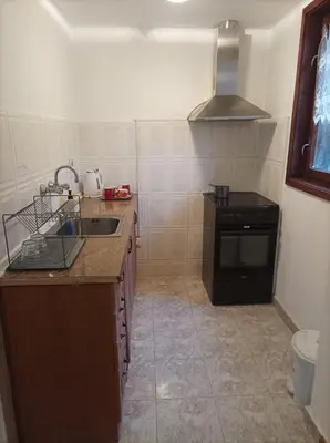 a small kitchen with a sink and a stove at Apartment Marchela in Nesebar