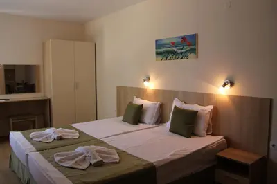 a hotel room with a bed with towels on it at Karlovo Hotel in Sunny Beach
