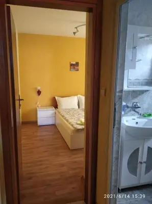 a small room with a bed and a sink at Sozopol House Dimitrovi in Sozopol