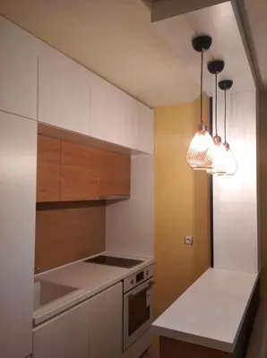 a kitchen with a white counter top and wooden cabinets at Sozopol House Dimitrovi in Sozopol
