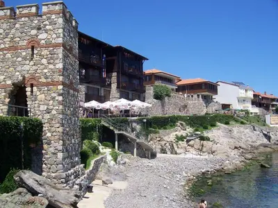 a stone building next to a body of water at Sozopol House Dimitrovi in Sozopol