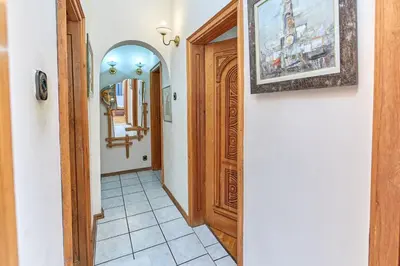 a hallway with a door and a picture on the wall at Апартамент Бриз in Burgas City