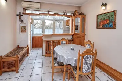 a kitchen with a table and chairs in a room at Апартамент Бриз in Burgas City