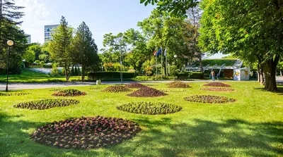 a park with a flower garden in the grass at Апартамент Бриз in Burgas City