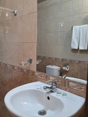 a bathroom with a white sink and a mirror at Hotel Elica in Varna City