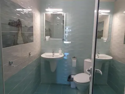 a bathroom with two sinks and a toilet and a mirror at Къща Веси VeSea in Nesebar