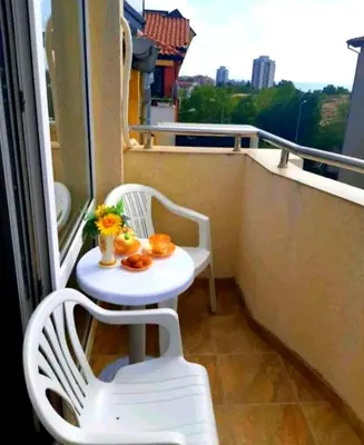 a balcony with a table and chairs on a balcony at Къща за гости Вълчеви Несебър in Nesebar