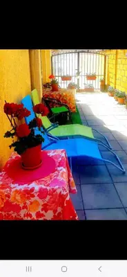 a room with a table with flowers on it at Къща за гости Вълчеви Несебър in Nesebar