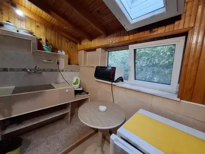 a small kitchen with a sink and a table in a room at Odesos Apartments in Varna City