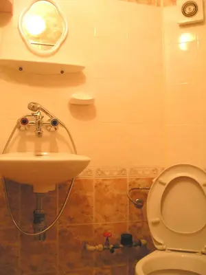 a bathroom with a sink and a toilet at Odesos Apartments in Varna City