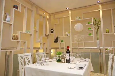 a dining room with a table with a white table cloth at Hotel Fors in Burgas City